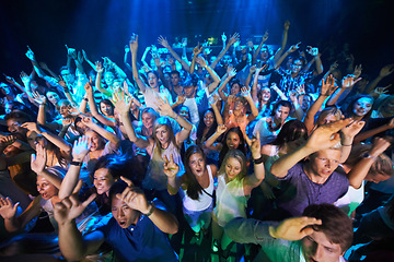 Image showing Dance, music and party with audience at concert for rock, festival or disco with live band performance. Celebration, social and nightclub show with crowd of fans listening for rave or new year event