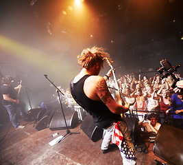 Image showing Rock, music festival and band guitar performance with crowd, fans and people cheering. Punk concert, man musician and fun social party event with music celebration and new year show at nightclub