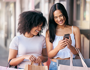 Image showing Shopping, phone and women or friends sales, discount or promo code check on a website, social media and retail store for e commerce. City, urban street and young customer people smartphone with bag