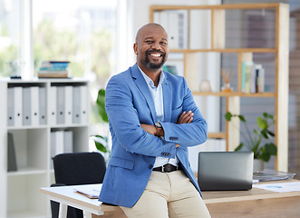 Image showing Success, corporate leadership and portrait of black man sitting on desk in modern office for startup. Management, marketing ceo and happy male entrepreneur with business vision in creative workplace