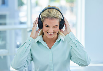 Image showing Business woman, headphone and listening to music, podcast and streaming on break in the office with happy smile. Female employee listen to audio, happiness and smiling while enjoy time off from job