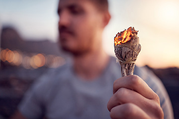 Image showing Man, burning sage and zen meditation outdoor for spiritual health, chakra wellness or to cleanse negative energy. Mindfulness, aromatherapy and male relaxing, meditating outside and performing ritual