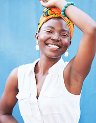 Image showing Fashion, happy glow and face of a black woman advertising jewelry, clothes and makeup against a blue background in studio. Color, marketing cosmetics and portrait of an African girl with happiness