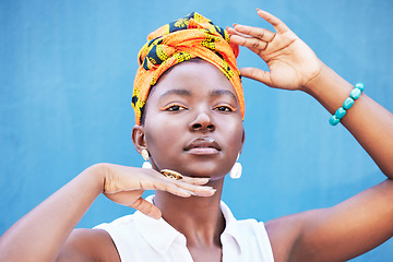 Image showing Fashion, Africa and portrait of black woman on blue background with natural beauty, glowing skin and makeup. Hands frame face of girl with African style or design cosmetics, head scarf and jewellery