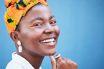Image showing Portrait, black woman and smile with head wrap, natural beauty or confidence for cosmetics on blue studio background. Jamaican female, girl or young lady with traditional headscarf, stylish or makeup
