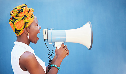 Image showing Black woman, megaphone and free space for freedom of speech, justice and equality on blue background for change, motivation and announcement. African female with microphone for protest or broadcast