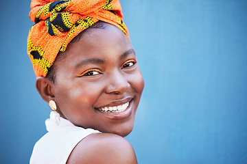 Image showing Black woman, face portrait and happy smile with makeup, beauty and fashion scarf on her head with blue wall background. Young female with natural cosmetics, happiness or smiling outdoor with mockup