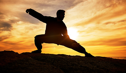 Image showing Man, meditation and silhouette, training and tai chi outdoor at a beach, wellness and calm with sunset background. Male, dark and shadow with martial arts, workout and meditate for a balance mindset