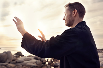 Image showing Meditation, peace and tai chi with man at beach for fitness, spiritual and healing energy. Relax, wellness and health with guy training with breathing exercise for zen, balance and martial arts