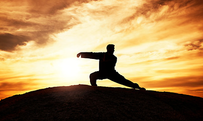 Image showing Tai chi, exercise and man at sunset to practice a spiritual workout in nature with an athlete. Silhouette, martial arts training and male fitness practitioner doing chi gong on a hill at sunrise