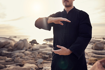 Image showing Health, fitness and tai chi with a man using martial arts for spiritual wellness and exercise by the beach. Fit, strong and asian zen lifestyle with chi gong by the seaside and a male active person
