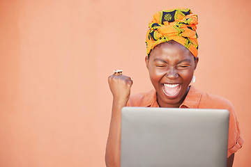 Image showing Success, celebration and black woman on laptop after winning on an orange studio background mock up. Face, winner and female on computer after online lottery win or reading good news on social media.