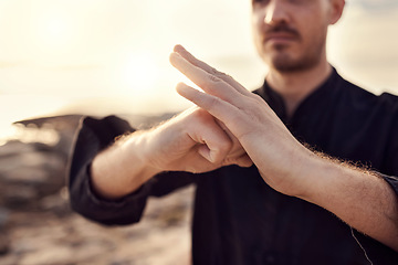 Image showing Karate, welcome or hands of zen man with peaceful, calm or mindfulness in nature at a beach for meditation. Fitness, sunset or martial arts teacher training with focus, motivation or spiritual energy