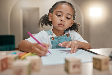 Image showing Girl, homework and writing on paper, learning and homeschool with math, education and knowledge at table in home. Latino child or student in brazil with concentration, school work and study in house