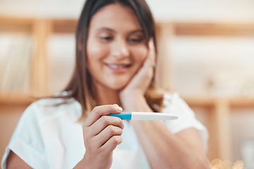 Image showing Hand, pregnancy test and results with a surprised woman looking at a home testing kit with a positive reading. Mother, pregnant and wow with a young female in her house with an excited expression