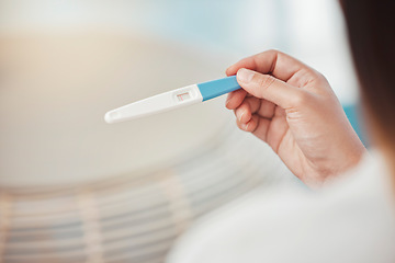 Image showing Woman, hands and pregnancy test with negative results, information and lines at home. Closeup of girl check infertility with stick for maternity, family planning and ovulation for prenatal healthcare