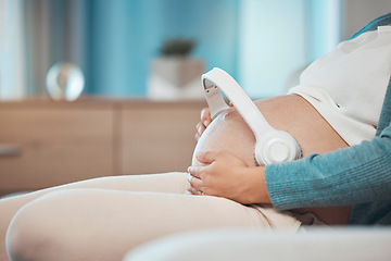 Image showing Relax music, pregnant and stomach of a woman on the sofa for peace, calm and sound for baby during pregnancy. Radio love, streaming and mother with audio therapy with headphones for child on tummy