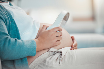 Image showing Relax, pregnant woman and headphones on stomach, music playing for baby in living room. Pregnancy, earphones on belly and technology, woman on sofa streaming audio sound for child listening in utero.