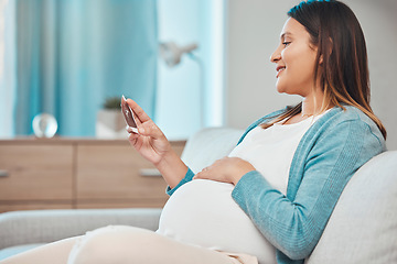 Image showing Pregnant, ultrasound and woman sitting on a sofa in the living room of her home with a baby bump or belly. Mother, pregnancy and photograph with a female parent in her house to relax alone