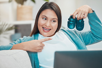 Image showing Video call, laptop and baby shoes with a mother making an online announcement about pregnancy. Pregnant, footwear and video conference on the internet with a woman excited about being a parent