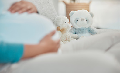 Image showing Mother, stomach and teddy bear in the background while relaxing on the sofa at home. Pregnancy, maternity and female rest in her house with toys while preparing for parenthood and motherhood