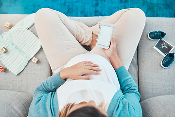 Image showing Woman, pregnant and phone screen, branding and mockup space for advertising, social media and relax on sofa with toys, above and baby cloths in home. Mother, 5g smartphone and reading online post