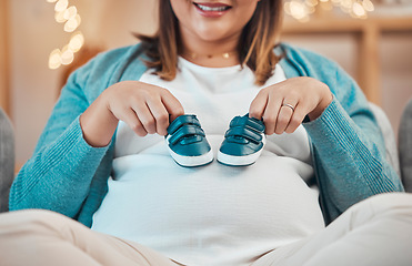 Image showing Pregnant mother, baby shoes and stomach while relax on sofa, happy smile and excited for childbirth in home. Woman, pregnancy and pregnancy with pregnant woman, maternity and motherhood in house