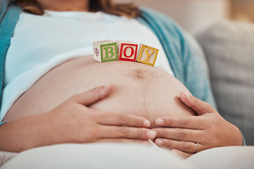 Image showing Pregnancy, blocks and woman hands on stomach or relax on sofa in living room for calm parenthood, childcare and mother support. Pregnant woman, wellness and stomach or baby growth with mom on couch