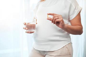 Image showing Pregnancy, health and woman with pills and water for wellness, vitamins and medical care for baby. Healthcare, medicine and pregnant woman hands with glass taking medication, minerals and supplements