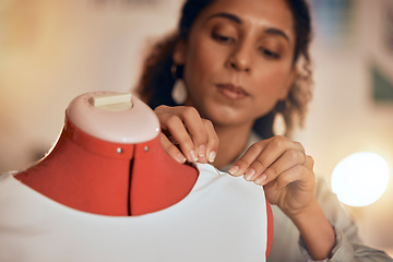 Image showing Fashion designer, hands and sewing fabric on a mannequin at night while working in workshop for manufacturing, production and design process. Female entrepreneur, dressmaker or tailor making clothes