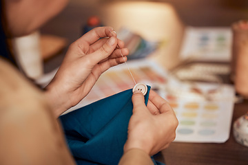 Image showing Hand, button and sewing with a woman designer working in fashion with a material or textile product. Creative, table and fabric with a female entrepreneur working in a studio to sew or tailor