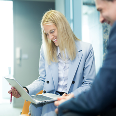 Image showing Business meeting. Client consulting. Confident business woman, real estate agent, financial advisor explaining details of project or financial product to client in office.