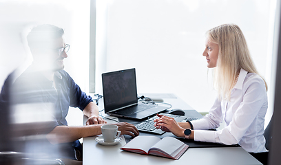 Image showing Business meeting. Client consulting. Confident business woman, real estate agent, financial advisor explaining details of project or financial product to client in office.