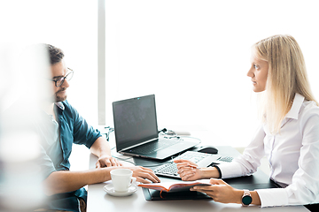 Image showing Business meeting. Client consulting. Confident business woman, real estate agent, financial advisor explaining details of project or financial product to client in office.