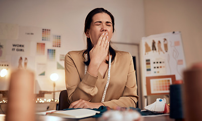 Image showing Tired fashion designer, woman and yawn while working at night in creative office, textile studio or startup. Exhausted, sleepy and overworked tailor yawning in burnout, stress and fatigue in workshop