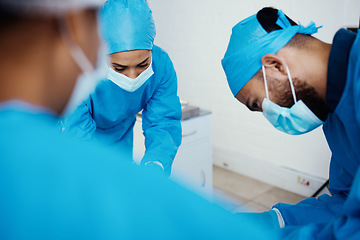 Image showing Covid, healthcare and surgery doctors in hospital for professional operation of patient. Focus, surgeons and medical people in theater with surgical face mask for protection and hygiene.