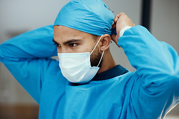 Image showing Head, doctor and prepare with mask for surgery in an operating room in a medical hospital. Surgeon, clinc and healthcare professional ready to operate while apply face mask and preparing