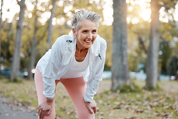 Image showing Tired, happy and senior woman running in outdoor nature park for retirement health, wellness and fitness workout. Healthcare exercise, path and runner with fatigue training for elderly marathon race