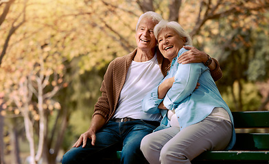 Image showing Senior couple, park bench and happy while sitting together in retirement for freedom, peace and calm with a smile and happiness in nature. Old man and woman outdoor to relax while on vacation