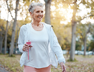 Image showing Fitness, nature and senior woman with water bottle for wellness, hydration and minerals for walking in park. Health, retirement and elderly female doing workout, exercise and cardio training outdoors