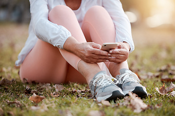 Image showing Phone, fitness and woman resting in nature after cardio workout training for race, marathon or olympics. Sports, exercise and female athlete running on break scrolling on social media with cellphone.