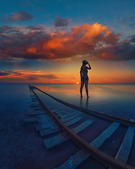 Image showing Woman at beauty sunset on salty lake