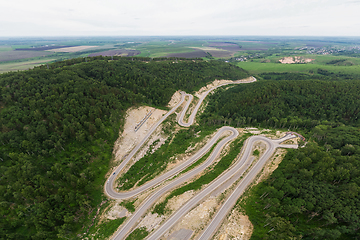 Image showing Aerial top vew of winding road in the mountains