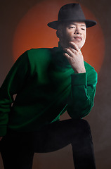 Image showing Aesthetic, fashion and black man with vitiligo in studio isolated on a background. Thinking, beauty and stylish male model posing in designer hat, luxury clothing or trendy green jersey on a backdrop