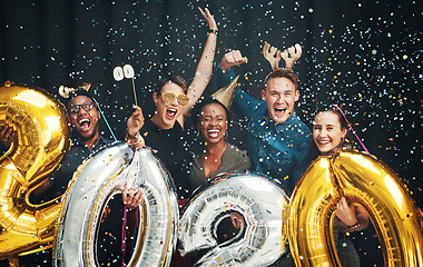 Image showing Portrait, 2020 and new year with friends together in studio on a black background for celebration or fun. Happy, smile and confetti with a man and woman friend group bonding while celebrating