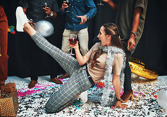 Image showing Woman, dancing and wine for celebration with friends on floor with confetti, alcohol and dance moves for new years, birthday or Christmas event. Drunk female with drink to celebrate with people