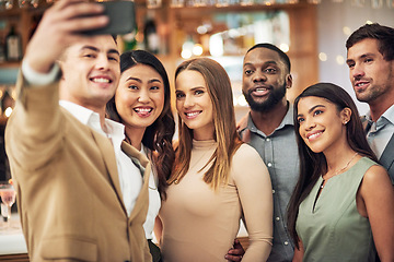 Image showing Group of friends, selfie and party for celebration, smile and bonding in restaurant. Diversity, young business people and corporate event for fun, relax and device to connect, social media and team.