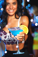 Image showing Hand, cocktail and party with a young woman in a nightclub for a new year celebration or event. Blue, drink and glass with a female in a club, enjoying a birthday while drinking alcohol at night