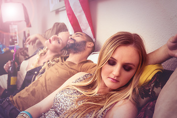 Image showing Drunk, sleeping and real people at a party on a sofa with a hangover from a celebration at a house. Tired, alcoholic and young man taking a nap with women on a couch at a home event in America.