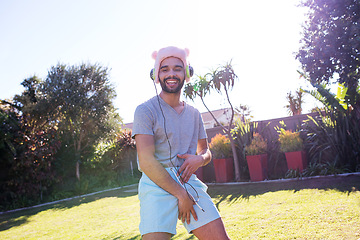 Image showing Music, drunk man dance at party streaming radio with headphones in garden outdoor. New year celebration, event and male listening to funny song or audio while partying for fun and dancing on backyard